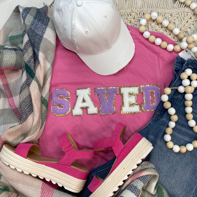 Chenille Embroidered Patch SAVED, decorative letter patch with purple and white colors and gold borders, displayed with casual fashion accessories including pink sandals, a white cap, a pink t-shirt, denim jeans, and a beaded necklace.