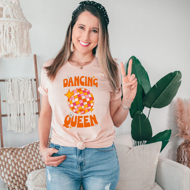 Dancing Queen Disco DTF Heat Transfer, a woman wearing a T-shirt with a colorful disco ball design and the words Dancing Queen.