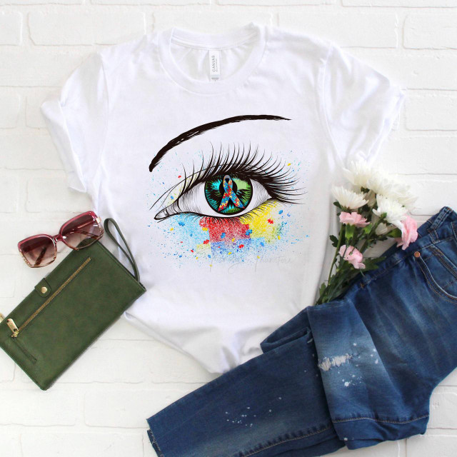 Autism Ribbon Awareness Glitter Eye Sublimation Transfer, a T-shirt featuring a detailed eye design with rainbow colors and an autism awareness ribbon in the pupil, surrounded by colorful paint splashes.