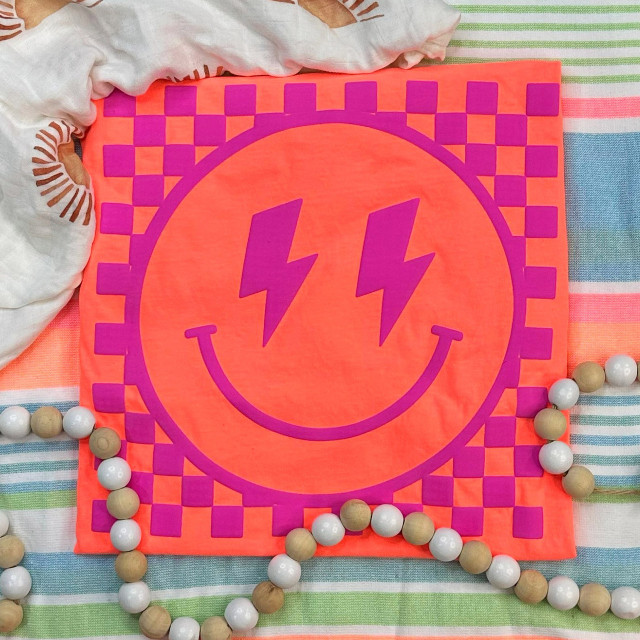 Checkered Happy Face PINK PUFF Screen Print Heat Transfer, bright pink and purple cheerful smiley face with lightning bolt eyes on a pink background.