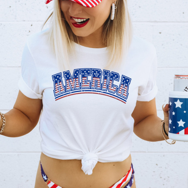 America Red PUFF Screen Print Heat Transfer, close-up of a woman wearing a white T-shirt with a patriotic American flag-themed puff print design, celebrating USA with a stylish and vibrant heat transfer.