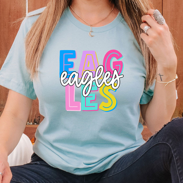 Eagles Colorful DTF Heat Transfer - Multicolored graphic design of the word "Eagles" in vibrant hues on a light blue t-shirt.