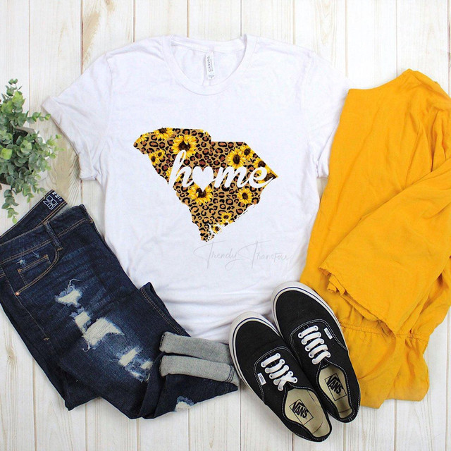 South Carolina with Home Leopard and Sunflower Sublimation Transfer, white t-shirt with a leopard print outline of South Carolina filled with sunflowers and the word 'home' written across it.