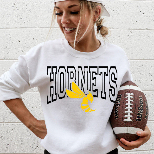 Hornets *CUSTOM COLOR OPTIONS* DTF Heat Transfer, printed yellow hornets logo on a white sweatshirt worn by a smiling woman holding an American football.