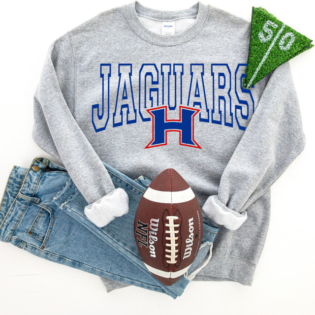 Jaguars H DTF Heat Transfer, image of a grey sweatshirt with the Houston Jaguars logo and name, alongside a football and a green textured fabric piece.