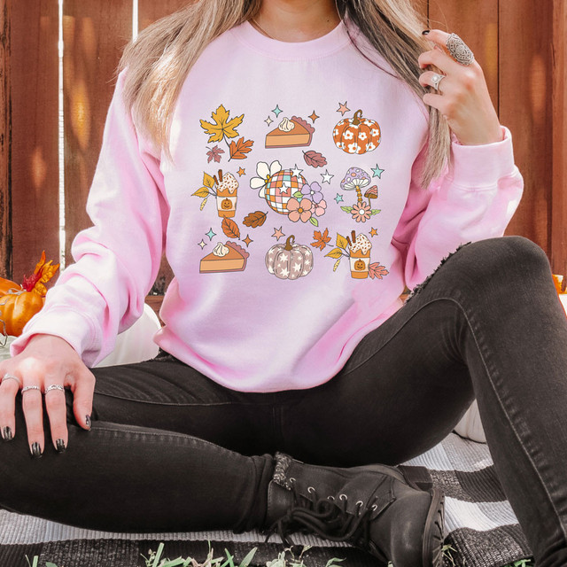 Retro Fall Disco DTF Heat Transfer, a colorful and stylish design featuring pumpkins, autumn leaves, mushrooms, and floral elements on a pink sweatshirt.