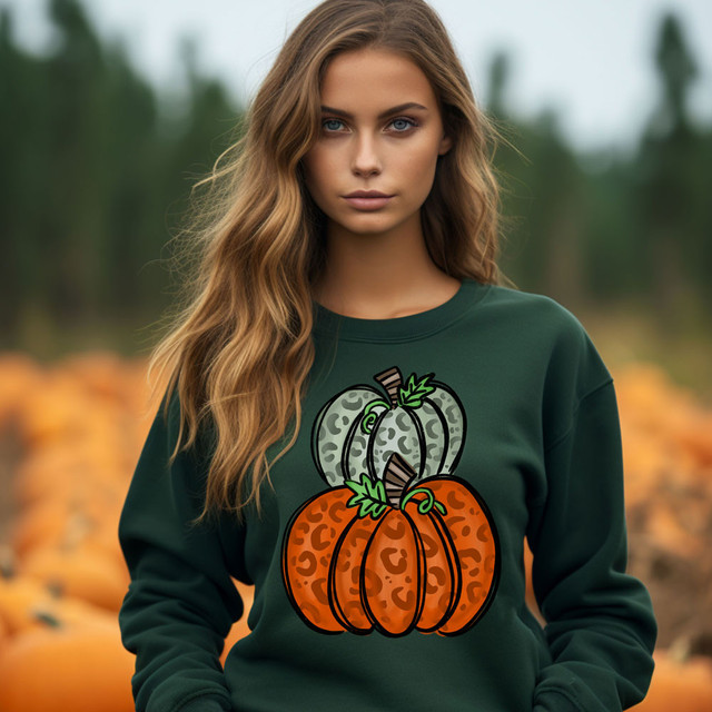 Leopard Fall Pumpkins DTF Heat Transfer, woman wearing green sweatshirt with leopard print pumpkins design for fall or Halloween decor.