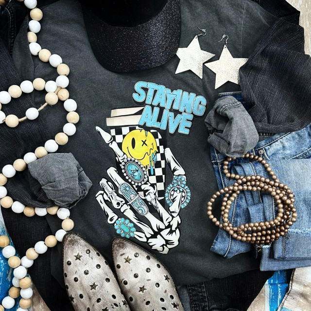 Staying Alive Screen Print Heat Transfer, a bright and colorful graphic design featuring a skeleton hand, a smiley face, and bold text for apparel customization.