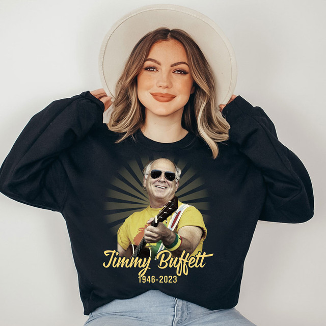 JB Memorial DTF Heat Transfer, memorial t-shirt honoring Jimmy Buffett with an image of him playing guitar and text reading 1946-2023.