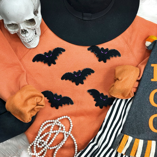 Mini Bat Chenille Patch, small black bat-shaped fabric appliqué with purple accents for Halloween decorations and crafts.