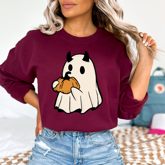 Ghost And Pumpkin DTF Heat Transfer, Halloween-themed ghost character holding a pumpkin on a maroon sweatshirt.