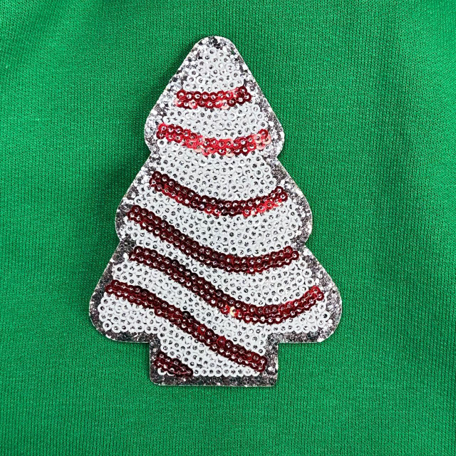 Mini Snack Cake Sequin Patch, decorative patch with white, red, and black sequins creating a snack cake design on green fabric background.