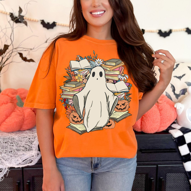 Book Ghost DTF Heat Transfer, Halloween-themed ghost design on an orange T-shirt with books, pumpkins, and flowers.