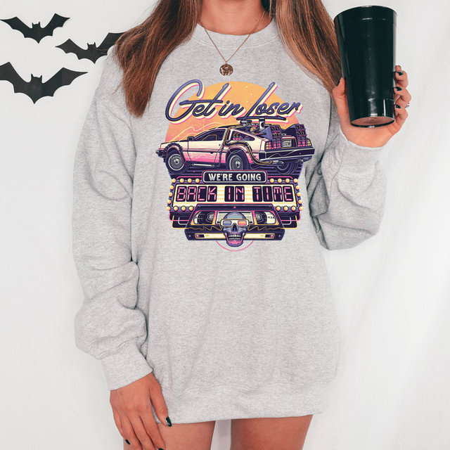 We're Going Back In Time DTF Heat Transfer, colorful retro-style design on a gray sweatshirt with a DeLorean car, skull, and neon lights