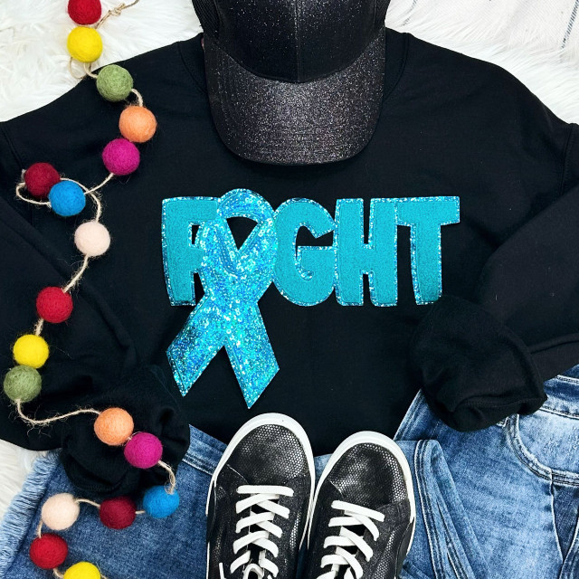 Teal Ribbon Fight Sequins Chenille Patch, a decorative patch with a teal ribbon and sequins on a black sweatshirt.