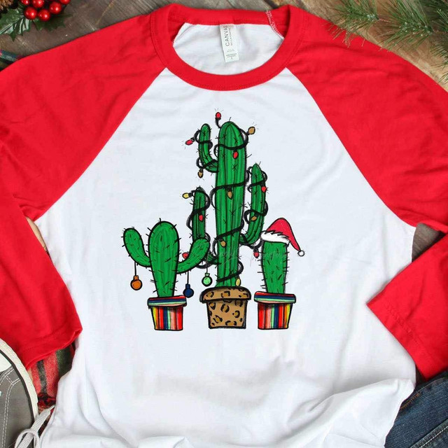 Cactus Christmas Tree Sublimation Transfer, festive cactus design with Christmas lights and Santa hat on one cactus, on a white and red long sleeve shirt, holiday apparel.
