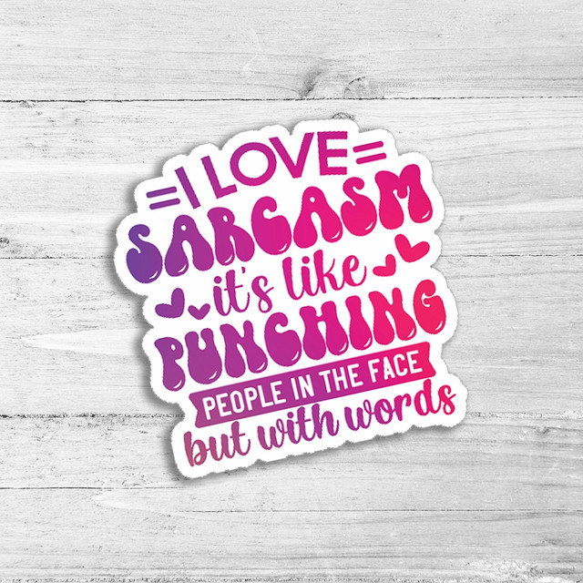 I Love Sarcasm Die Cut Sticker, humorous sticker with colorful text stating 'I love sarcasm, it's like punching people in the face but with words' on a wooden background.
