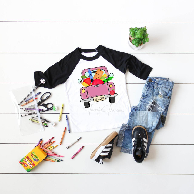 Back To School Pink Vintage Truck Sublimation Transfer, colorful school supplies and casual children's clothing arranged on white wooden background.