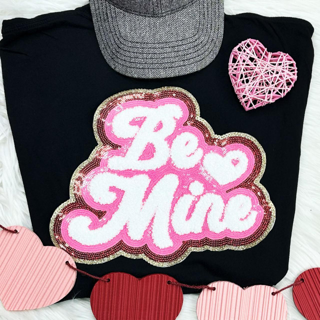 Be Mine Sequin Chenille Patch, colorful decorative patch with the words 'Be Mine' in white sequins and pink outlines on a black fabric background.