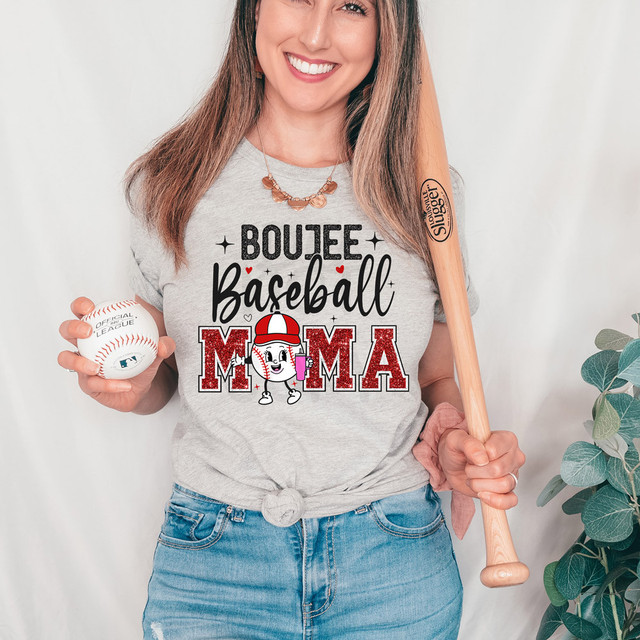 Boujee Baseball Mama DTF Heat Transfer, a woman wearing a gray t-shirt with the design, holding a baseball and a baseball bat.
