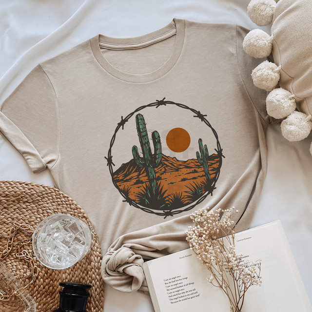 Desert Barbed Wire DTF Heat Transfer, desert landscape design with cacti, mountain, and sun on a beige t-shirt.