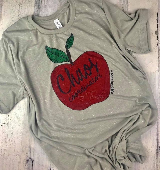 Teacher Life Chaos Coordinator Sublimation Transfer T-Shirt, gray shirt with a red apple graphic and handwritten style text for teachers.