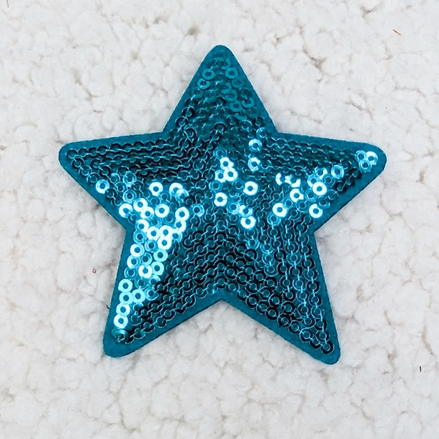 Flat BLUE sequin STAR HAT/POCKET Patch, image of a shiny blue star-shaped patch decorated with sequins on a soft, textured background.