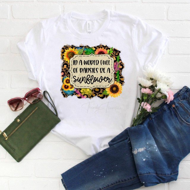 In a world full of pansies be a sunflower sublimation transfer, floral and animal print sublimation transfer design on a white T-shirt.