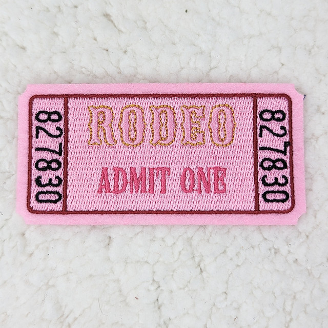 Rodeo Ticket Embroidered HAT/POCKET Patch, pink fabric patch with embroidered yellow, black, and pink ticket design and text.