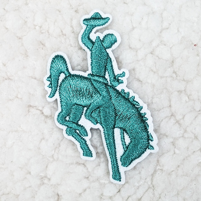 Turquoise Rodeo Cowboy HAT/POCKET Patch, embroidered patch featuring a cowboy riding a bucking horse with a turquoise color and detailed stitching.