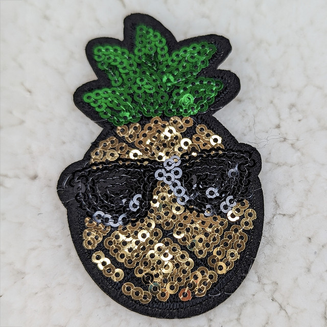 Pineapple Sequin HAT/POCKET Patch, embroidered patch with green sequined leaves, black sequined pineapple body, and gold sequined accents.