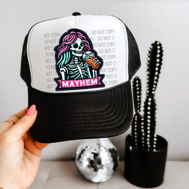 Mayhem Faux Patch Sublimation Transfer, colorful skeleton with pink and teal hair sipping a drink on a black and white trucker hat.