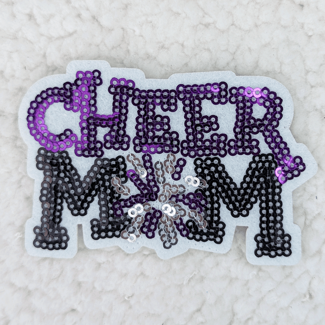 PURPLE Sequin Cheer Mom HAT/POCKET Patch, beadwork spelling out 'CHEER MOM' with a flower accent in purple, black, silver, and white sequins on a felt backing.