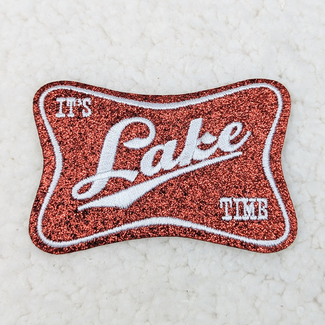 It's Lake Time Embroidered Glitter HAT/POCKET Patch, red glitter patch with white embroidered text and border with a wavy shape.