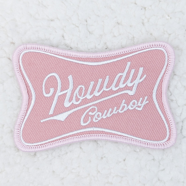Howdy Cowboy Embroidered HAT/POCKET Patch, pink fabric patch with white embroidered text and border for hats or pockets.