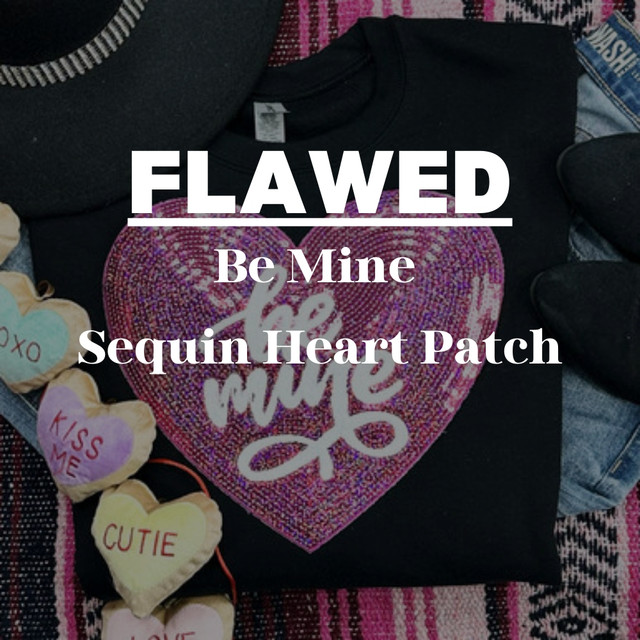 Flawed Be Mine Sequin Heart Patch, a decorative patch featuring shiny pink and purple sequins in the shape of a heart with the words 'love me' written in the center.