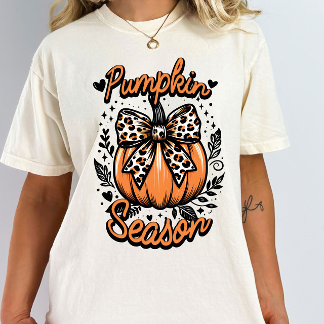 Leopard Bow Pumpkin Season DTF Heat Transfer, illustrated pumpkin with a leopard print bow, surrounded by decorative leaves and hearts for seasonal Halloween or autumn apparel.