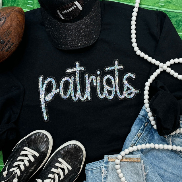 Patriots Sequin Patch, black sweatshirt with iridescent sequined 'patriots' text, surrounded by casual accessories like sneakers, pearl necklace, denim shorts, and a football.