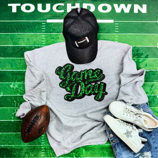 Green Sequins Game Day Patch, a shiny black cap with football patch, grey sweatshirt with 'Game Day' sequined text, white sneakers with star design, and a brown football on a green sports-themed background.