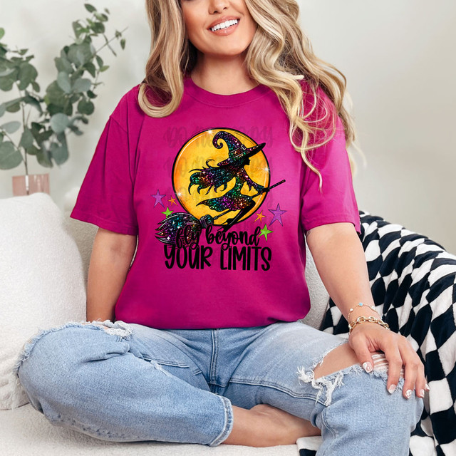 Fly Beyond Your Limits DTF Heat Transfer, vibrant witch illustration on a pink T-shirt with stars and a moon background.