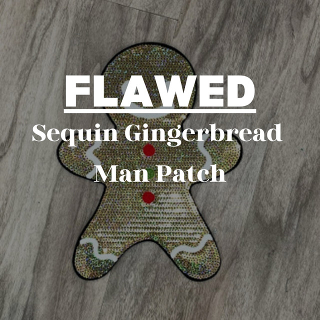 FLAWED Sequin Gingerbread Man Patch, embellished with sequins and featuring red buttons and white decorative accents on a wooden background.