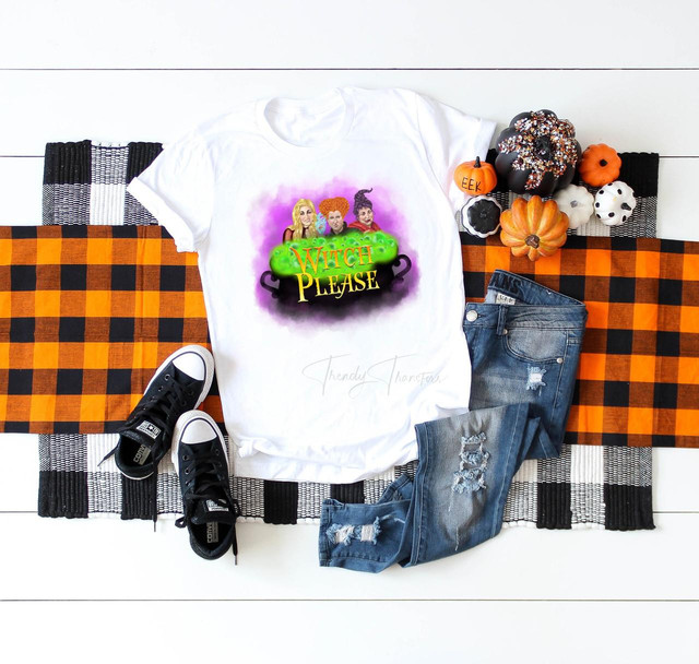 Witch Please Fan Art Hocus Pocus Sublimation Transfer, printed design featuring three cartoon witches and the text 'Witch Please' on a white t-shirt, surrounded by Halloween decorations and accessories.