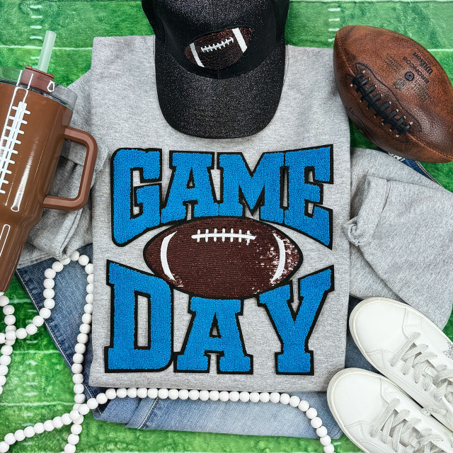 Light Blue Chenille Game Day T-shirt with Sequin Football Patch, sports-themed apparel with football graphics and bright colors.