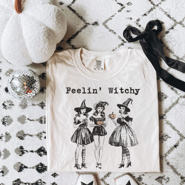 Feelin' Witchy DTF Heat Transfer, Halloween themed T-shirt with witch characters and pumpkin design.