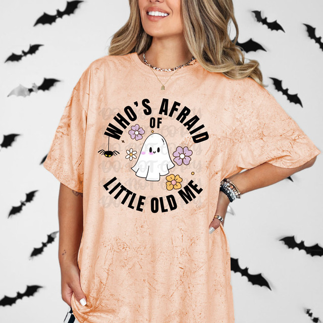 Who's Afraid Of Little Old Me Ghost DTF Heat Transfer, colorful cartoon ghost with flowers and playful text on peach-colored T-shirt