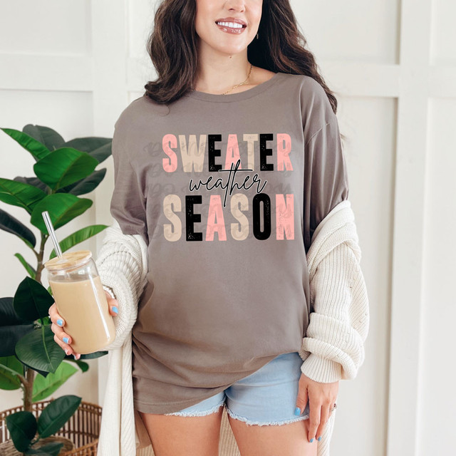Sweater Weather Season DTF Heat Transfer, close-up of a woman wearing a casual oversized sweatshirt with fall-themed text design.