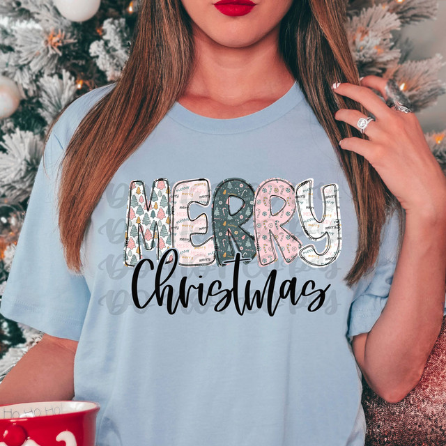 Merry Christmas Patterned Green/Pink DTF Heat Transfer, Christmas themed design on a light blue t-shirt.
