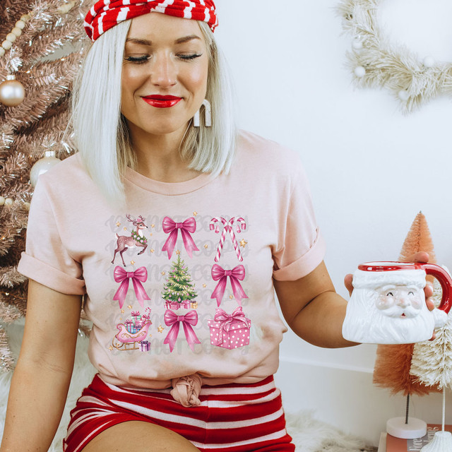 Pink Christmas Coquette DTF Heat Transfer, festive Christmas-themed design on a woman's pink t-shirt with bows, reindeer, presents, and candy canes, holiday decorations in background.