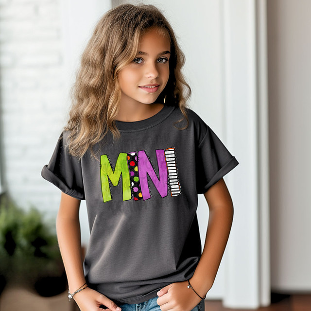 Mini Halloween Letters DTF Heat Transfer, colorful Halloween themed letter design on a girl's t-shirt.
