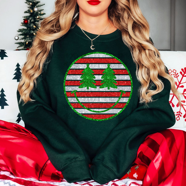 Christmas Tree Happy Face DTF Heat Transfer, festive holiday sweatshirt with a smiley face design made of two green Christmas trees and red, white, and green striped background.
